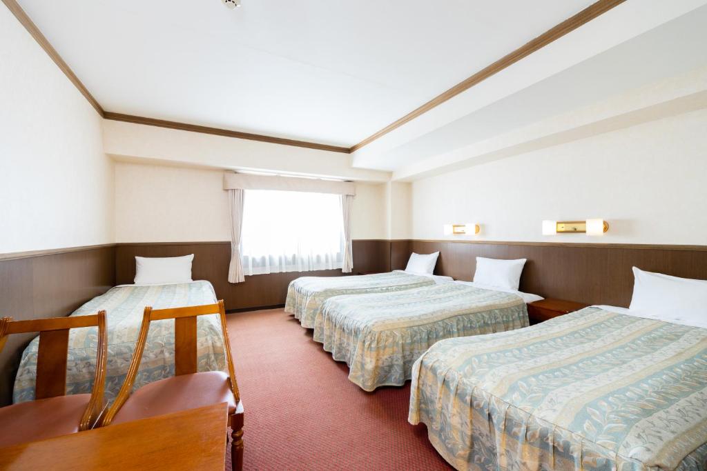 Postel nebo postele na pokoji v ubytování Gora Hotel Paipuno Kemuri Plus