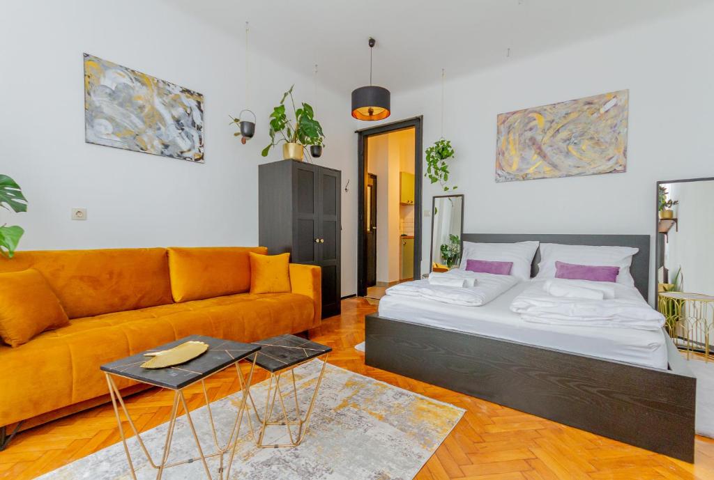 a living room with a bed and a couch at Central Studio @ Jászai Mari Square in Budapest