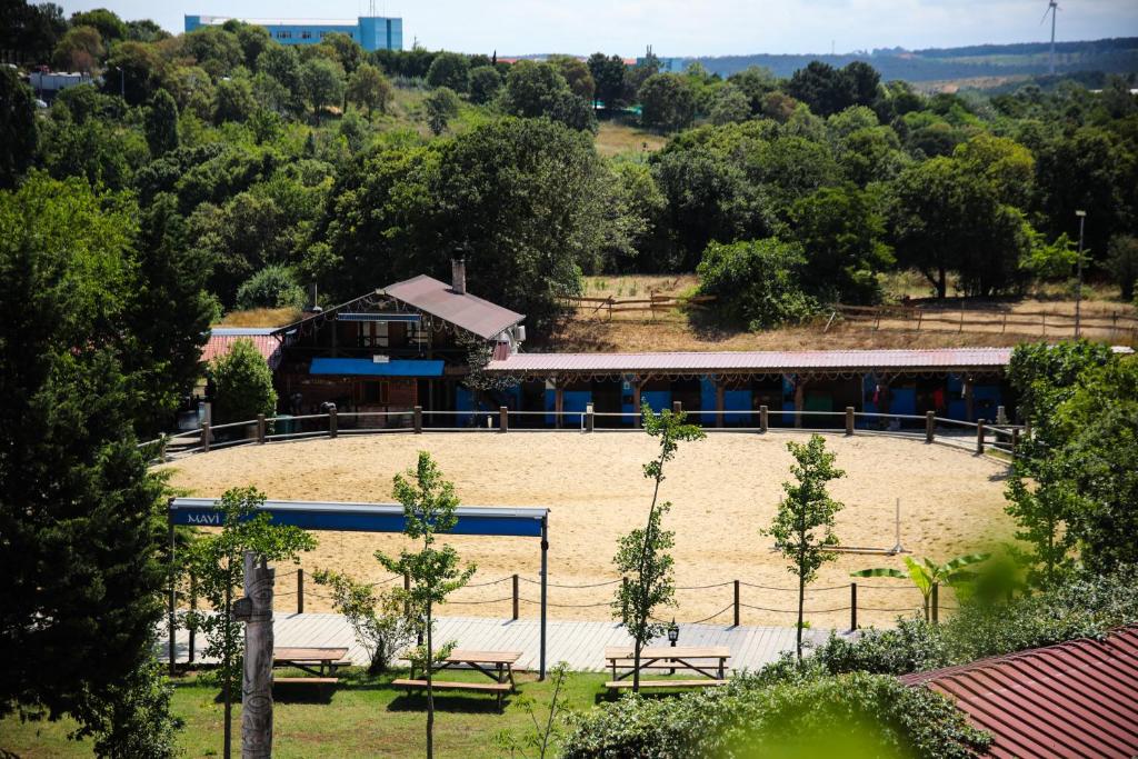a large arena with a building in the background at MAVİ AT HOTEL Blue Horse in Gümüşdere
