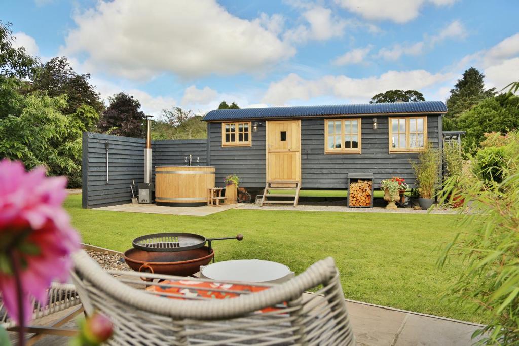 a tiny house in a garden with a grill at The Garden Rooms at Lonton in Durham