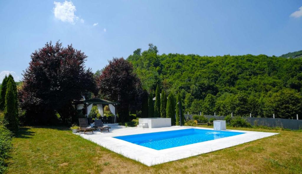 a swimming pool in a yard with a gazebo at Residence Green Pool & SPA in Visoko