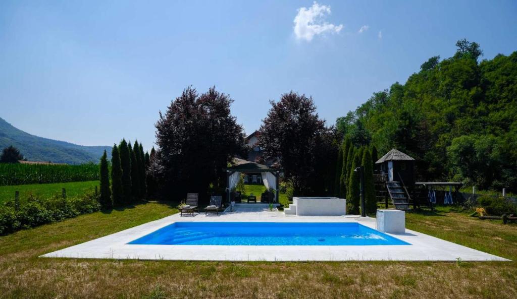 a swimming pool in the middle of a yard at Residence Green Pool & SPA in Visoko