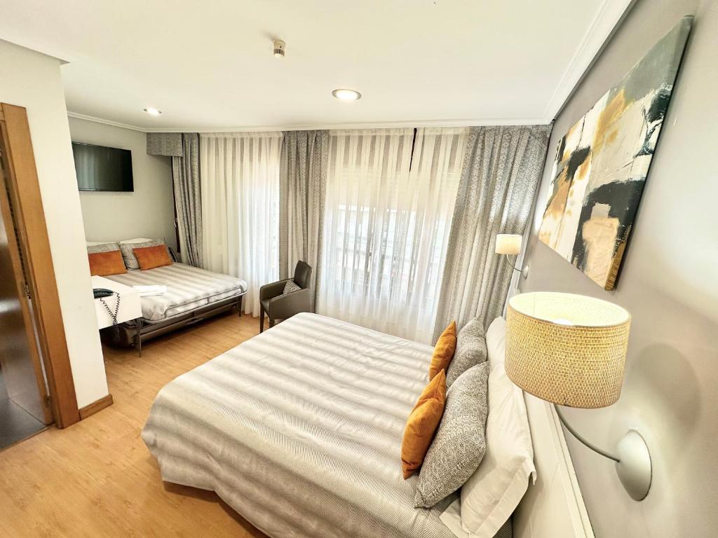 a hotel room with a bed and a bedroom at Hotel Las Olas in Noja
