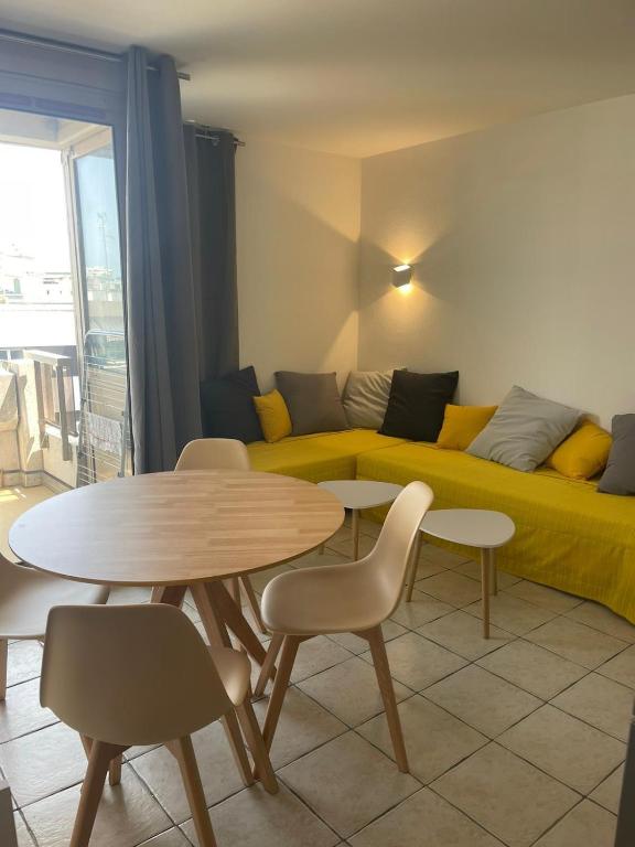 un salon avec un canapé, une table et des chaises dans l'établissement Résidence Graziella studio 605, à Juan-les-Pins