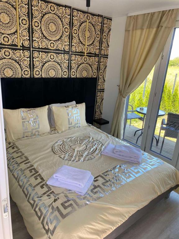 a bedroom with a large bed with a large headboard at MMA apartament in Klaipėda