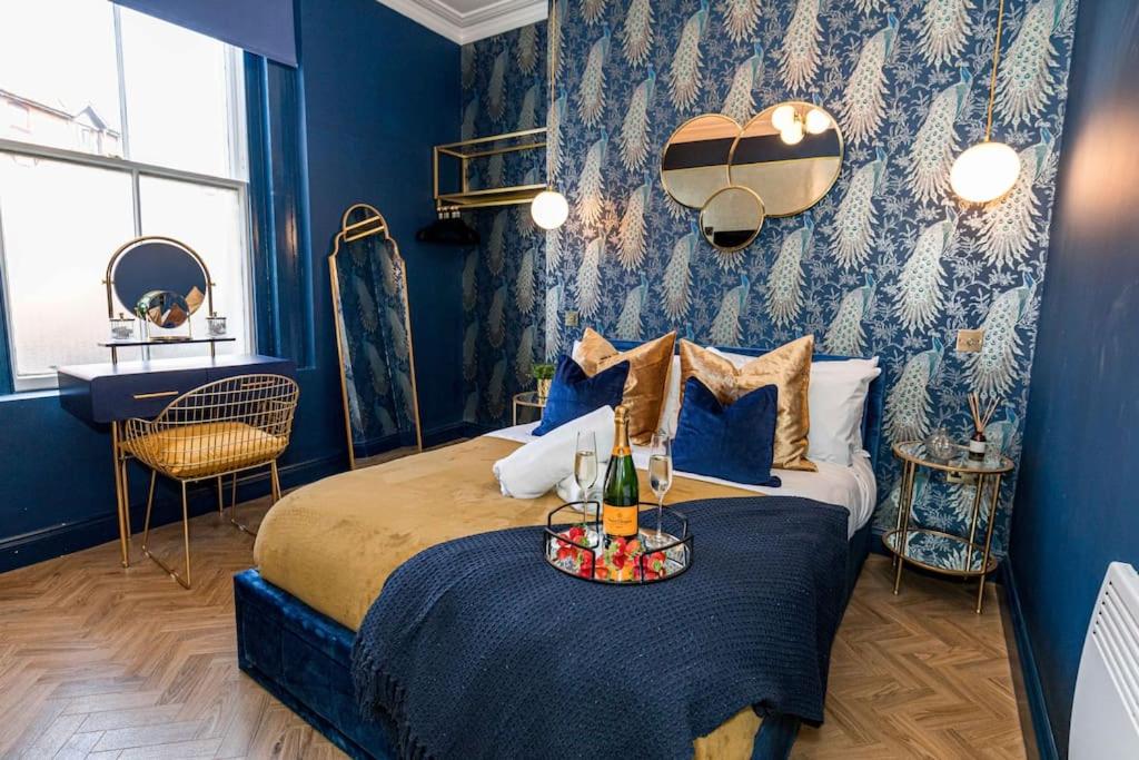 a blue bedroom with a bed with a tray on it at Luxury Accommodation In The City Centre With Free Parking in Bournemouth