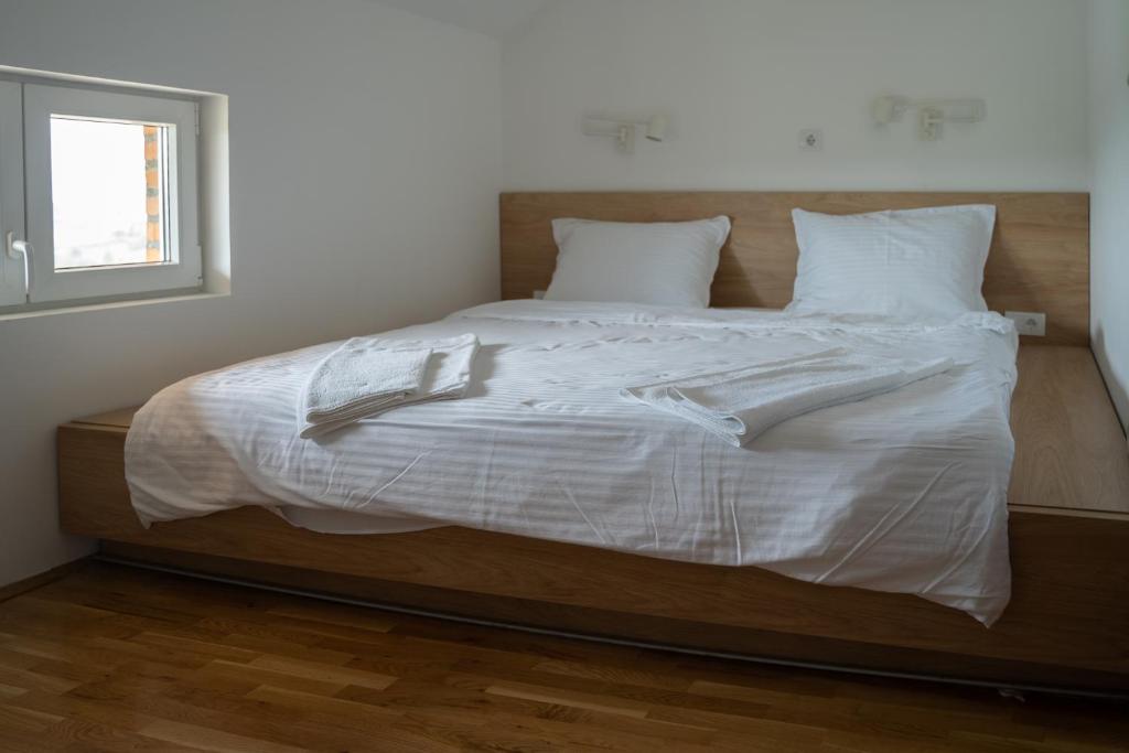 Postel nebo postele na pokoji v ubytování Apartmani Vinarije IN