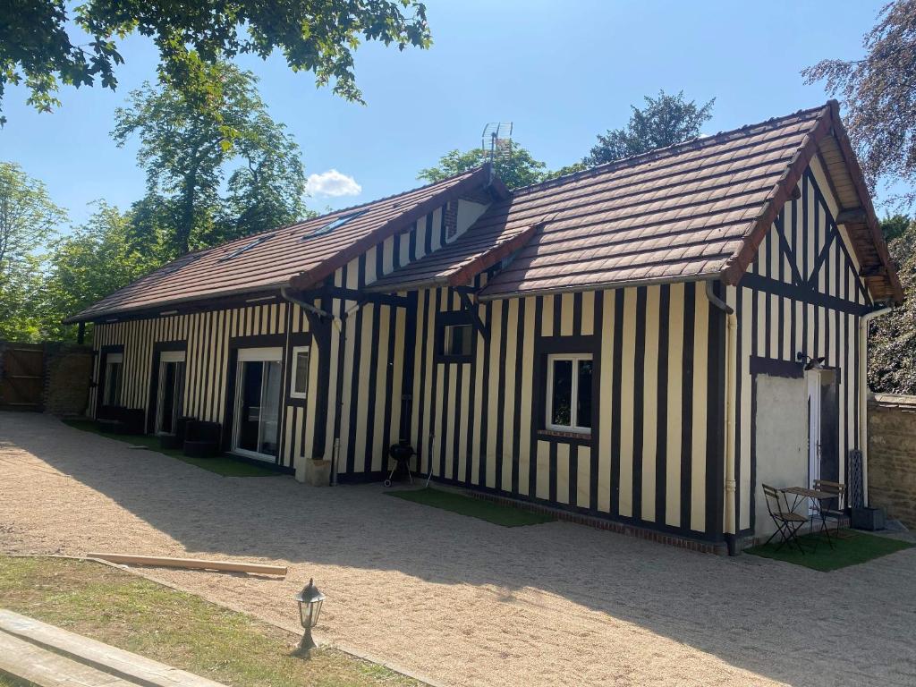 a building with black and white stripes on it at Au domaine des roches in Saint-Pierre-sur-Dives