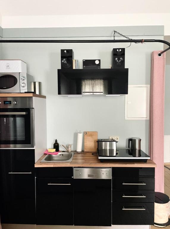 a kitchen with black and white appliances at Apfelhof Biesenbrow in Biesenbrow