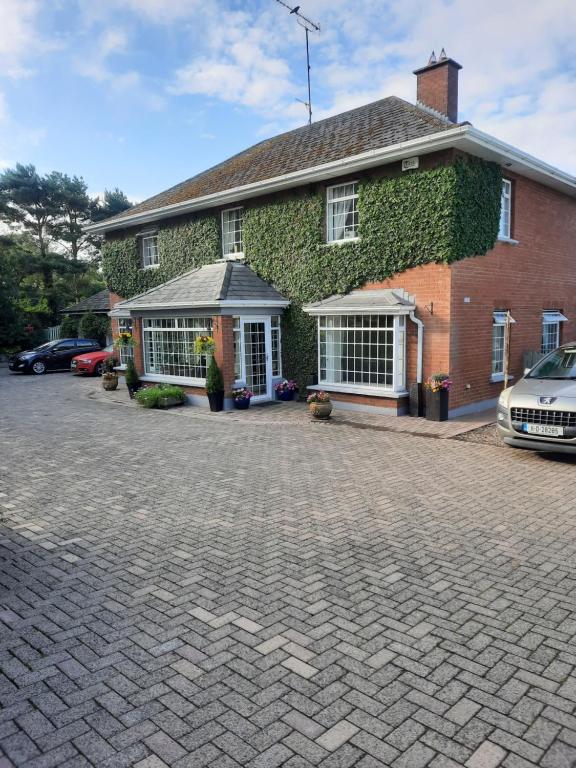 a brick house with ivy on the side of it at Butterhouse in Trim