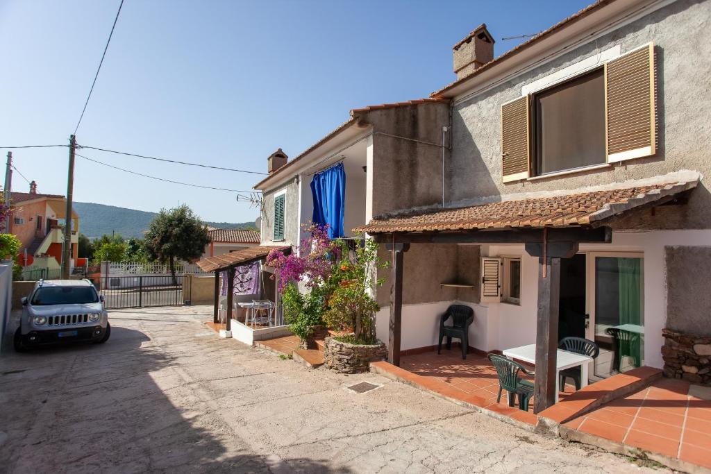 uma pequena rua com uma casa e um carro em Casa Isabella em Budoni