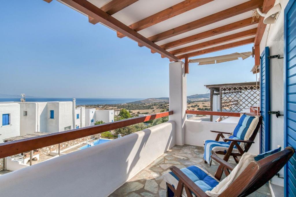 a balcony with chairs and a view of the ocean at Lovely Apartment With Shared Pool in Aspro Chorio Paros