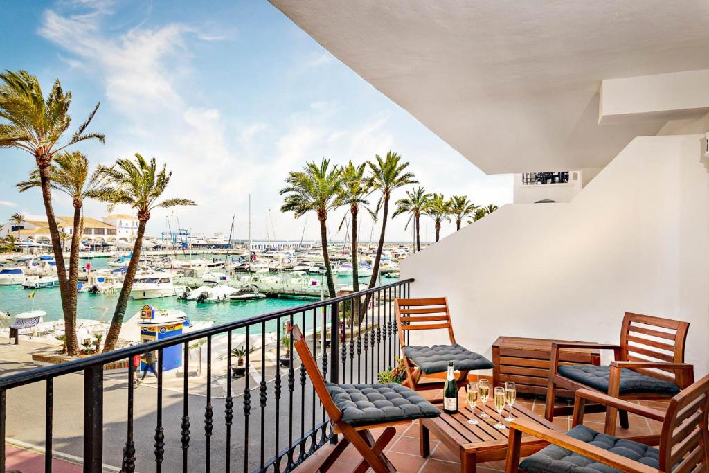 a balcony with chairs and a view of a marina at Marina Real 2434 in Manilva