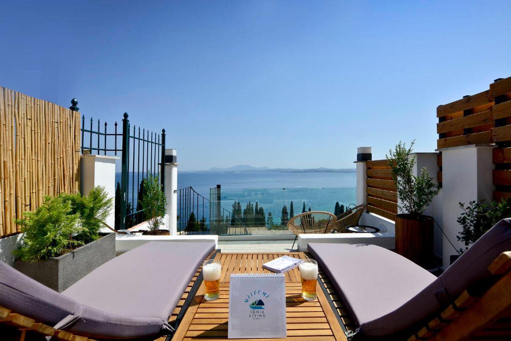 a patio with chairs and a table on a balcony at Ionia Living in Barbati