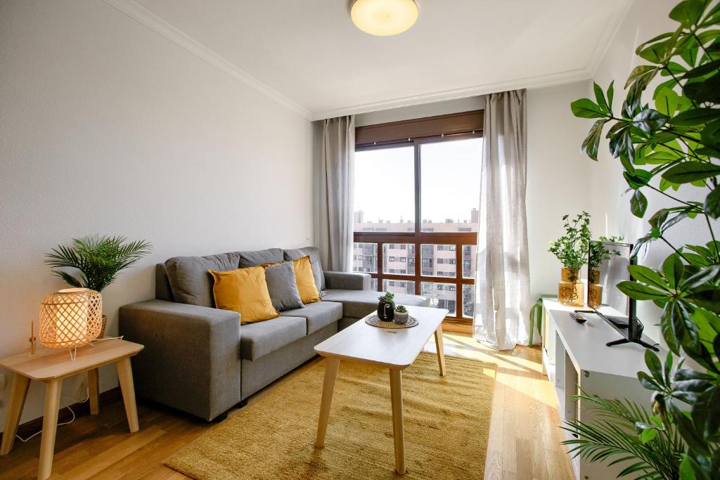 a living room with a couch and a table at Charming Madrid Airport in Madrid