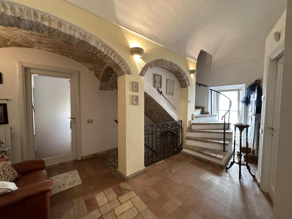 a living room with a staircase and a stair case at Villino Tokupellon Apartments in Cupello