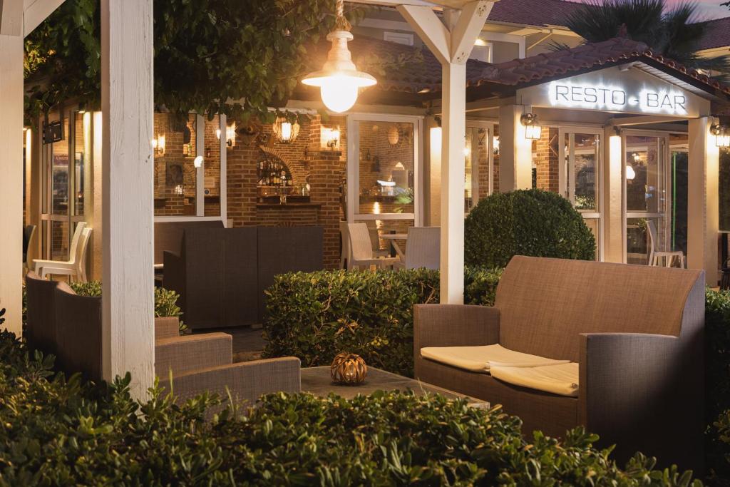 a restaurant with a table and chairs at night at Kalamaki Beach Hotel, Zakynthos Island in Kalamaki