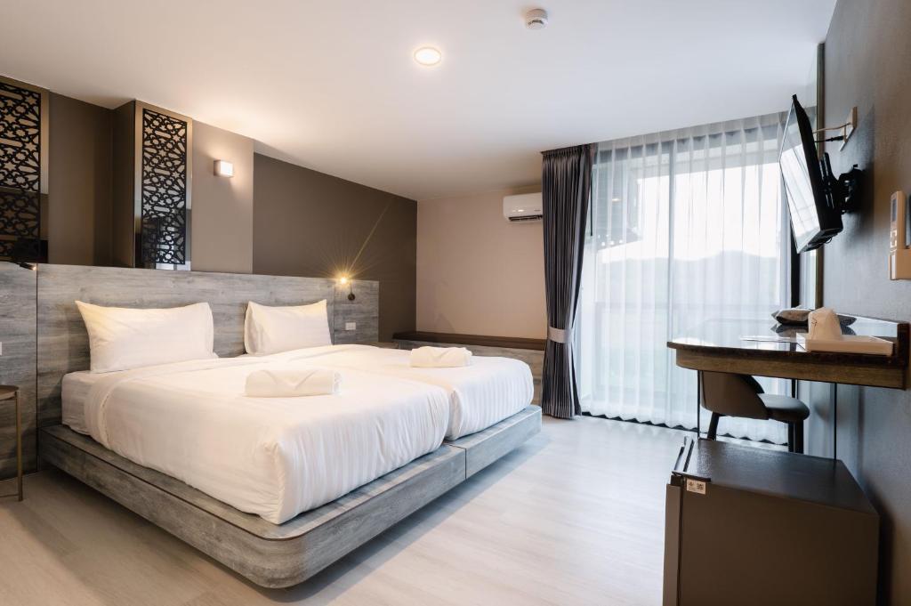 Postel nebo postele na pokoji v ubytování วัน บัดเจท เชียงราย เชียงแสน One Budget Hotel Chiangrai Chiangsaen