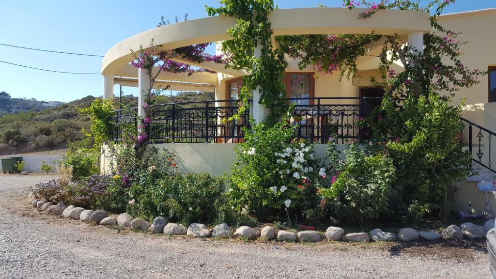 a house with flowers on the side of it at beautiful villa in Kefalos