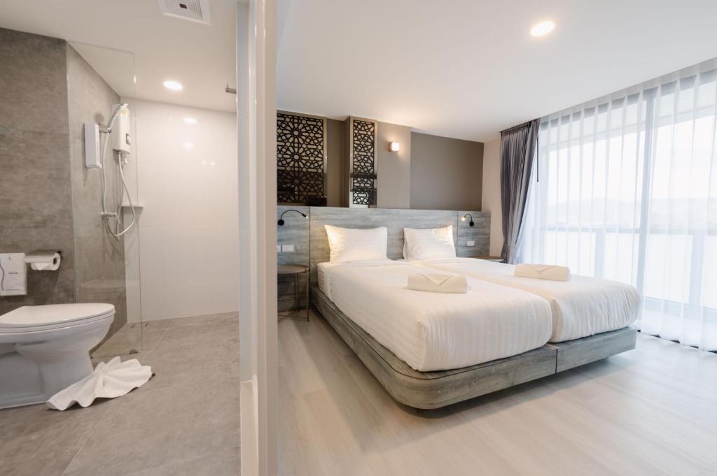 Postel nebo postele na pokoji v ubytování วัน บัดเจท เชียงราย เชียงแสน One Budget Hotel Chiangrai Chiangsaen