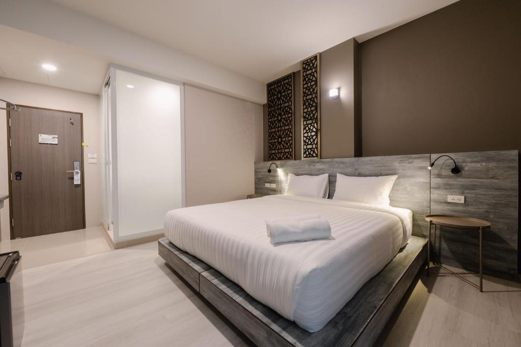 Postel nebo postele na pokoji v ubytování วัน บัดเจท เชียงราย เชียงแสน One Budget Hotel Chiangrai Chiangsaen