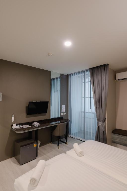 Postel nebo postele na pokoji v ubytování วัน บัดเจท เชียงราย เชียงแสน One Budget Hotel Chiangrai Chiangsaen