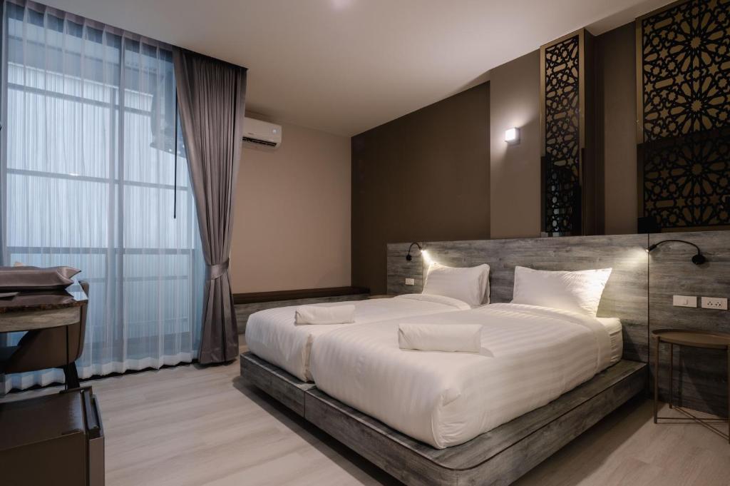 Postel nebo postele na pokoji v ubytování วัน บัดเจท เชียงราย เชียงแสน One Budget Hotel Chiangrai Chiangsaen