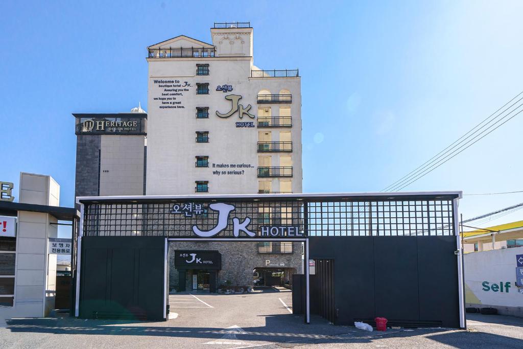 a building with a sign on the front of it at JK Hotel in Busan