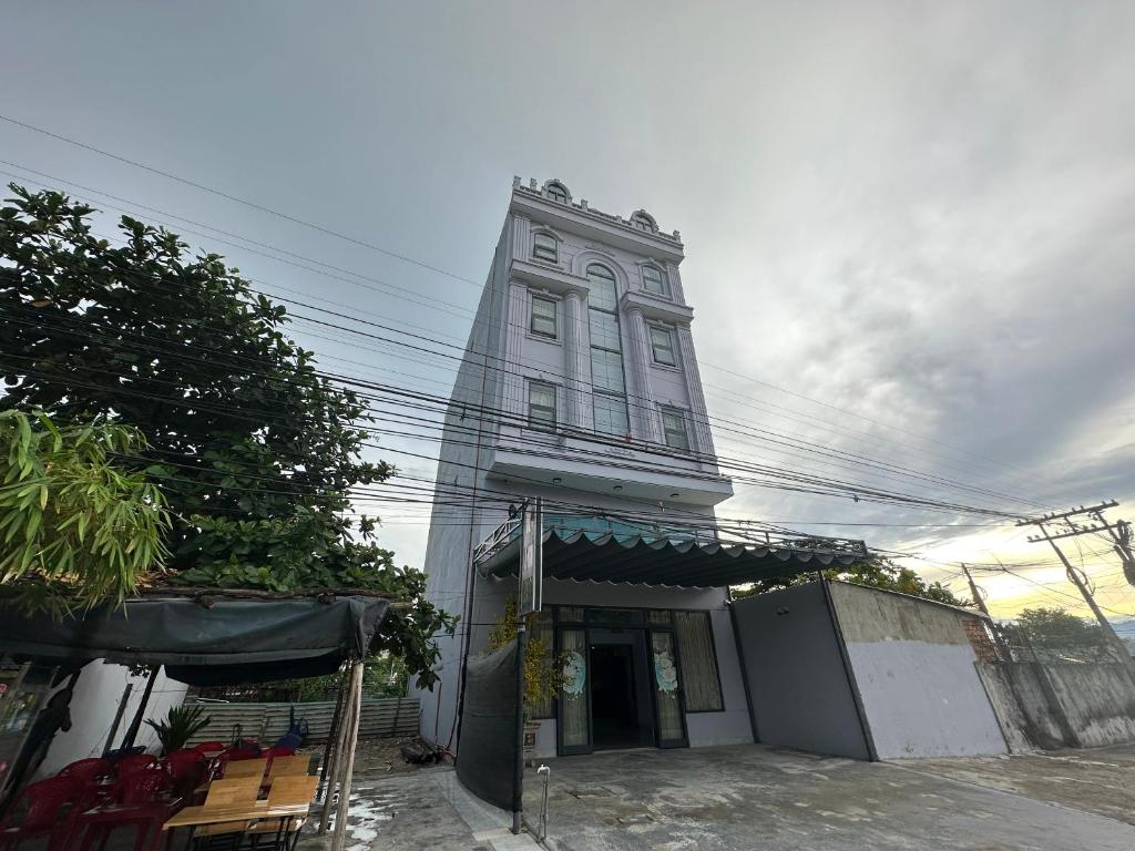 a tall building with a clock tower on a street at Valentin Hotel in Da Nang