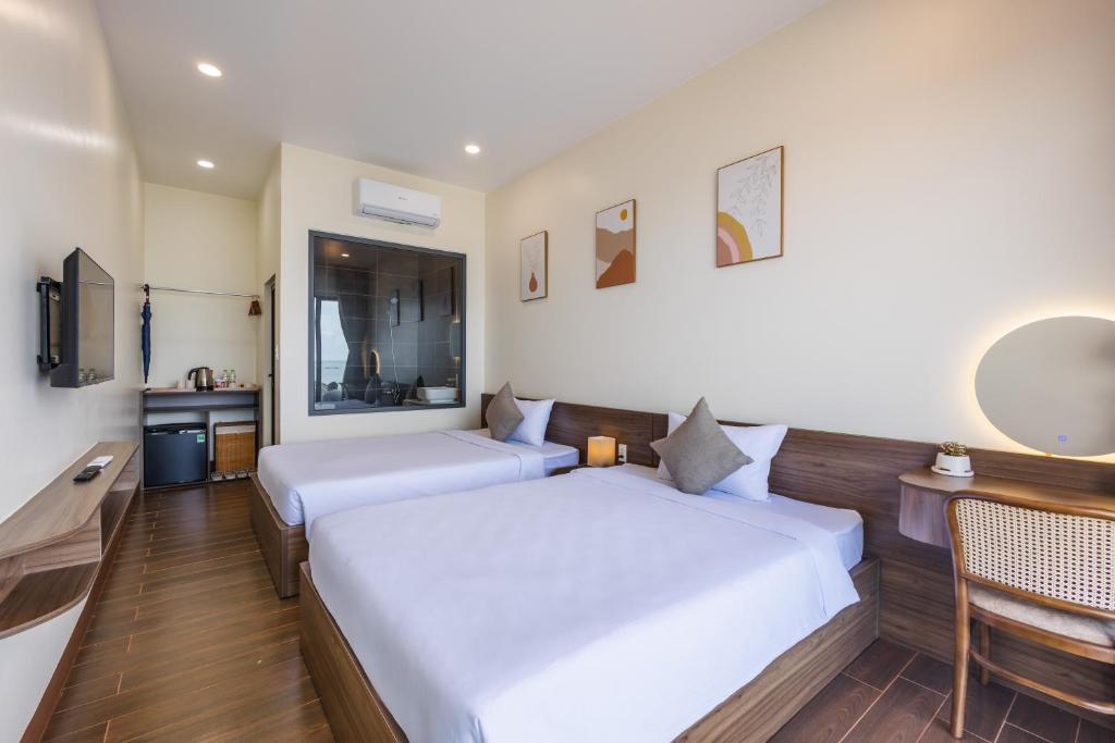 Giường trong phòng chung tại Wave Sound Beach House Phu Quoc