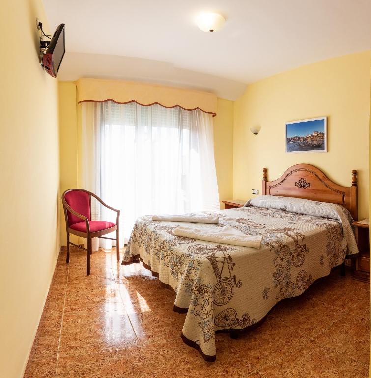 Posteľ alebo postele v izbe v ubytovaní Hostal O Camouco