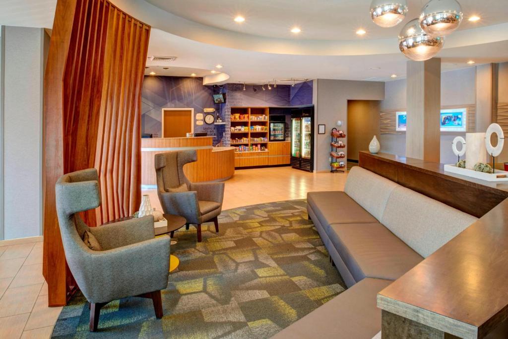 a living room with a couch and chairs at SpringHill Suites St. Louis Brentwood in Brentwood