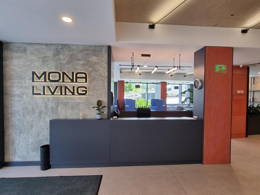 an office lobby with a memo living sign on the wall at Mona Living in Sofia