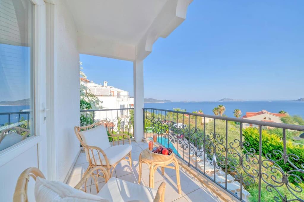 a balcony with chairs and a view of the ocean at Villa Pilu in Kaş