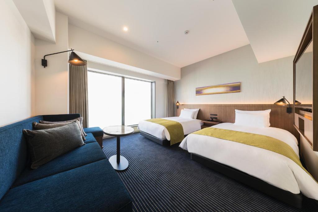 Postel nebo postele na pokoji v ubytování Hotel Metropolitan Kawasaki