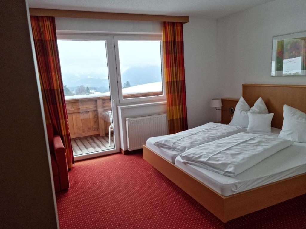 Postel nebo postele na pokoji v ubytování Gasthof und Hotel Rieder GmbH