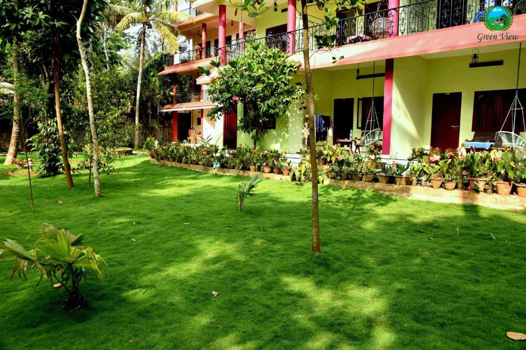 a green yard in front of a building at Green View in Thekkady