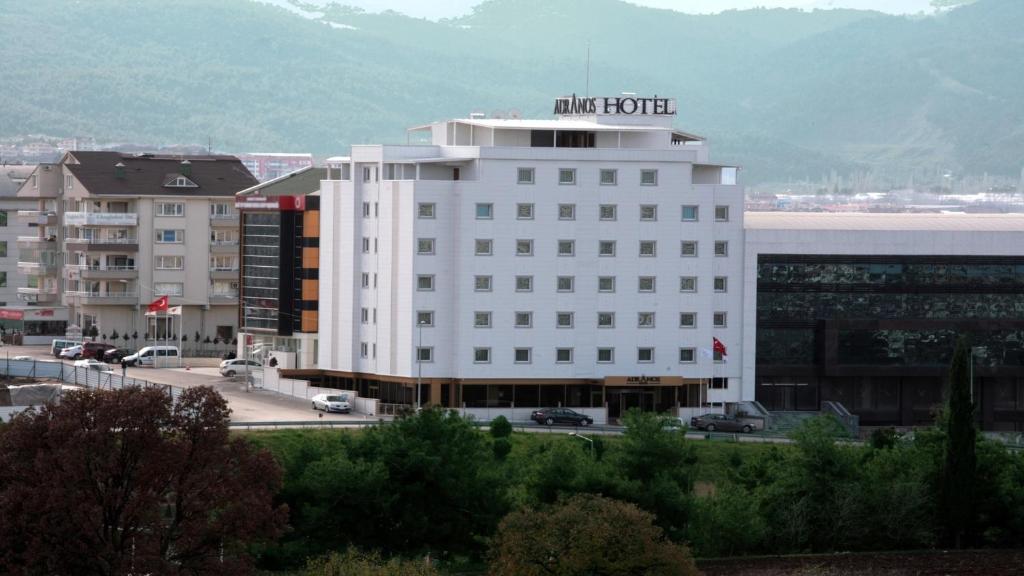 a white building with a hotel sign on top of it at Adranos Hotel in Bursa