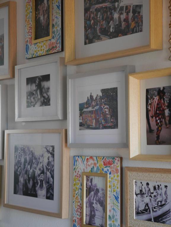 a bunch of pictures hanging on a wall at Hostel & Surfcamp 55 in Ericeira