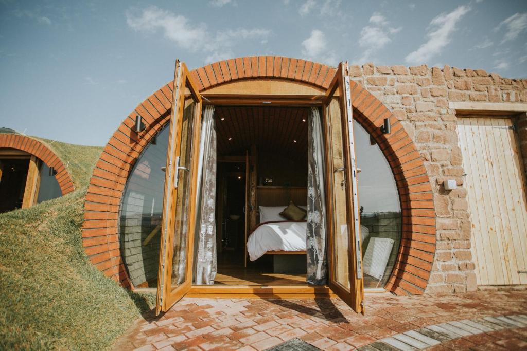 a circular room with a bed inside of it at Otters View in Rhayader