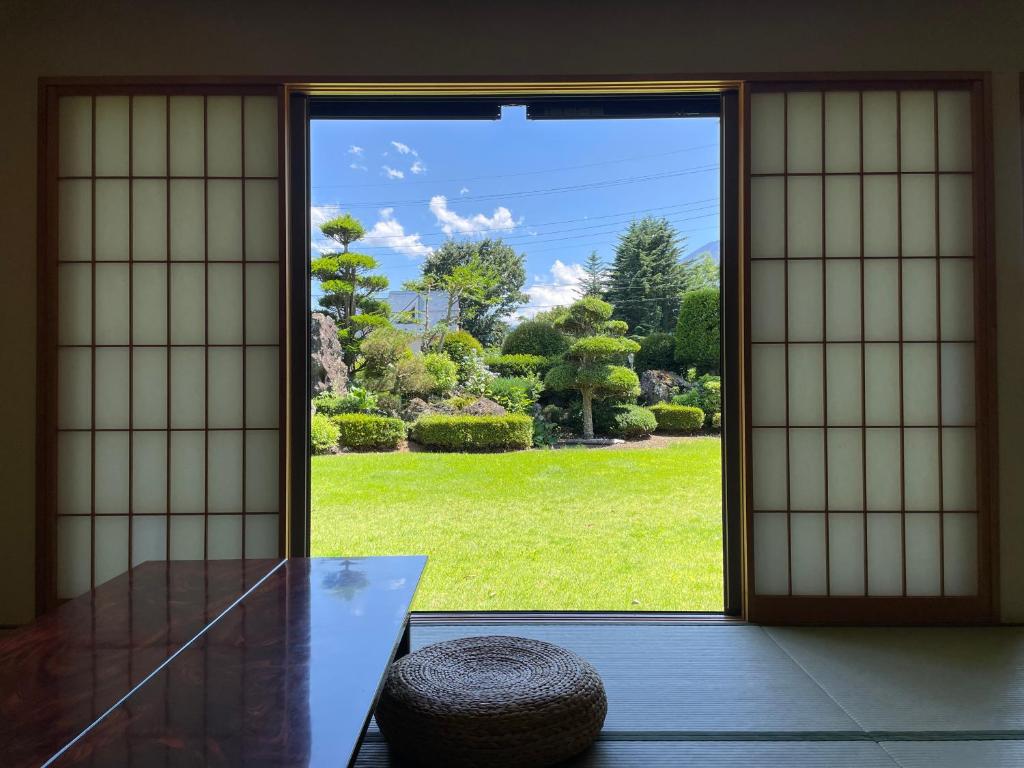 an open door with a view of a garden at Togawaso in Fujikawaguchiko