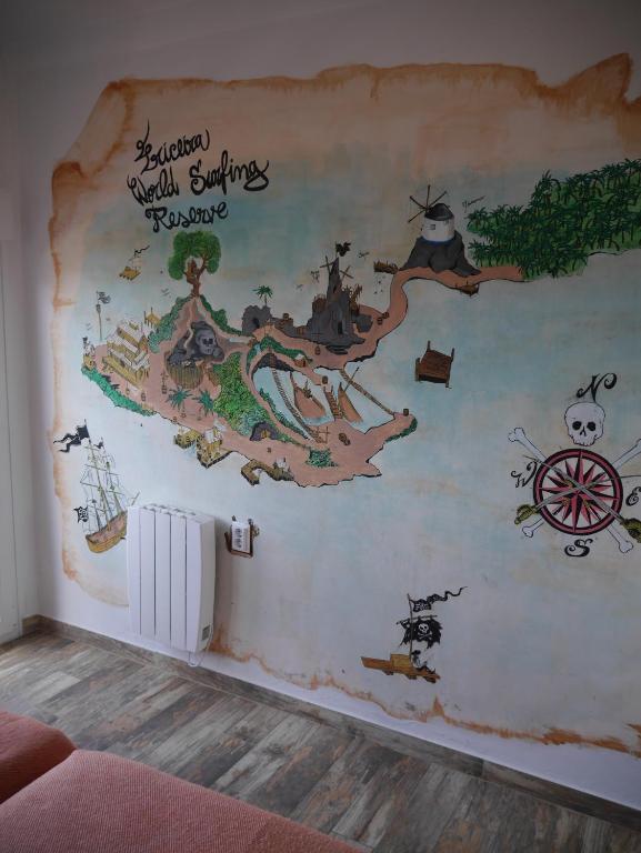 a wall mural in a room with a map at Hostel & Surfcamp 55 in Ericeira