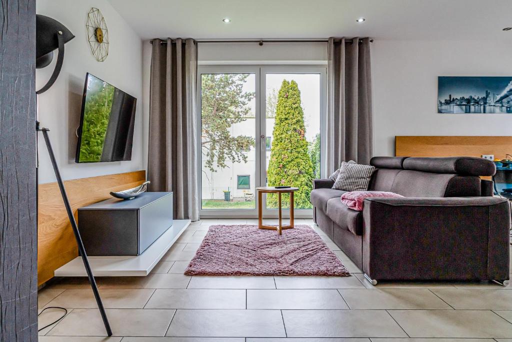 a living room with a couch and a table at Apartment#1 in Kerpen