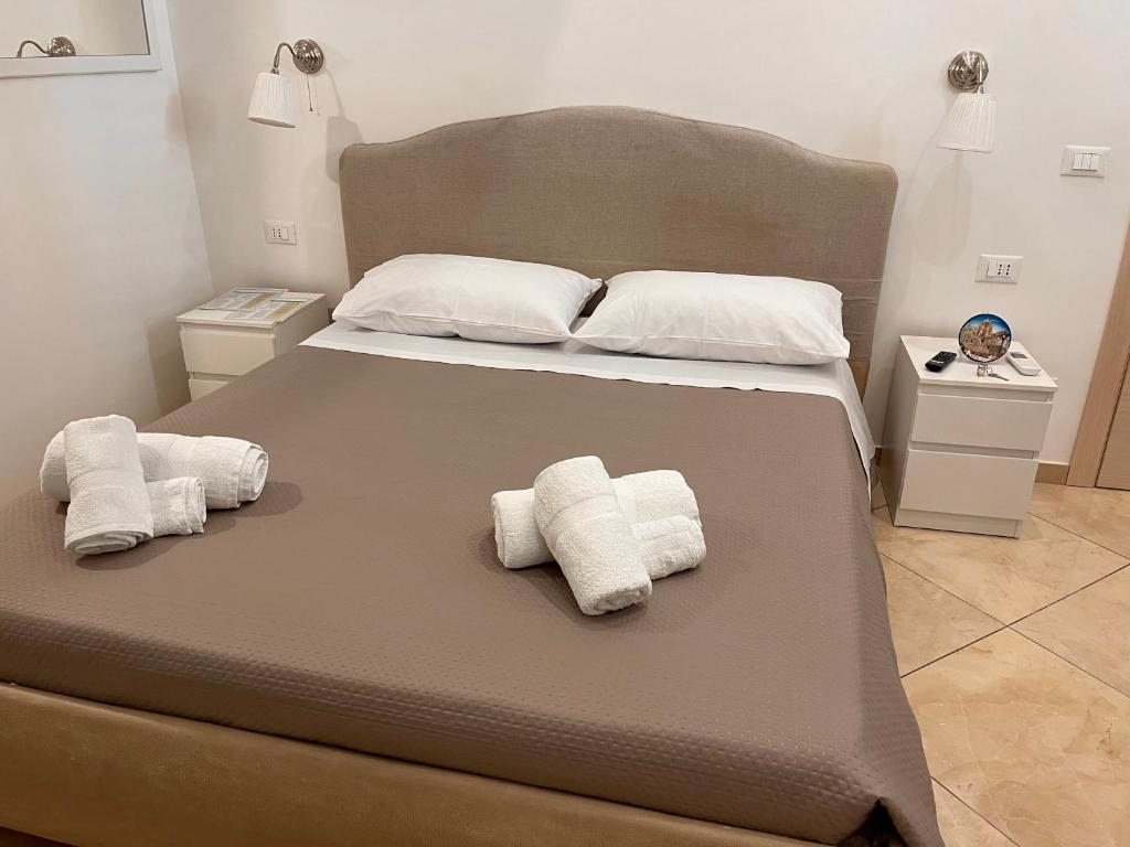 Postel nebo postele na pokoji v ubytování Esse House's Noto