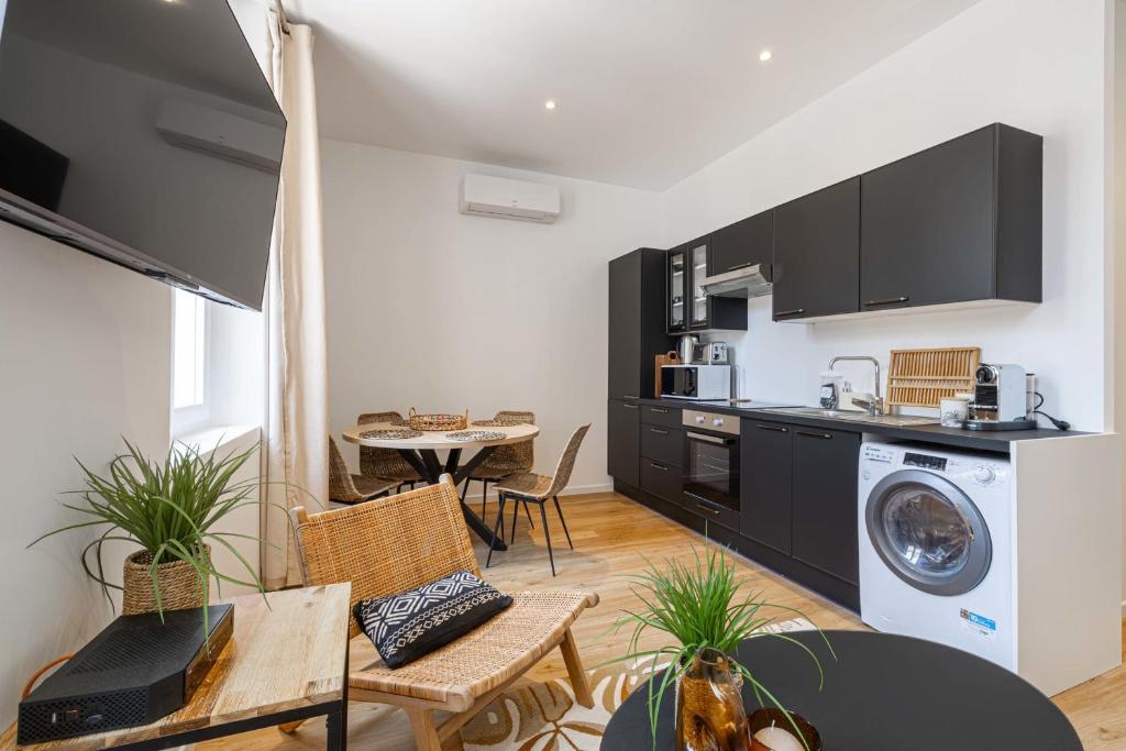 eine Küche und ein Wohnzimmer mit Waschmaschine und Trockner in der Unterkunft Nice decorated apartment - near Croisette - 1BR4p in Cannes