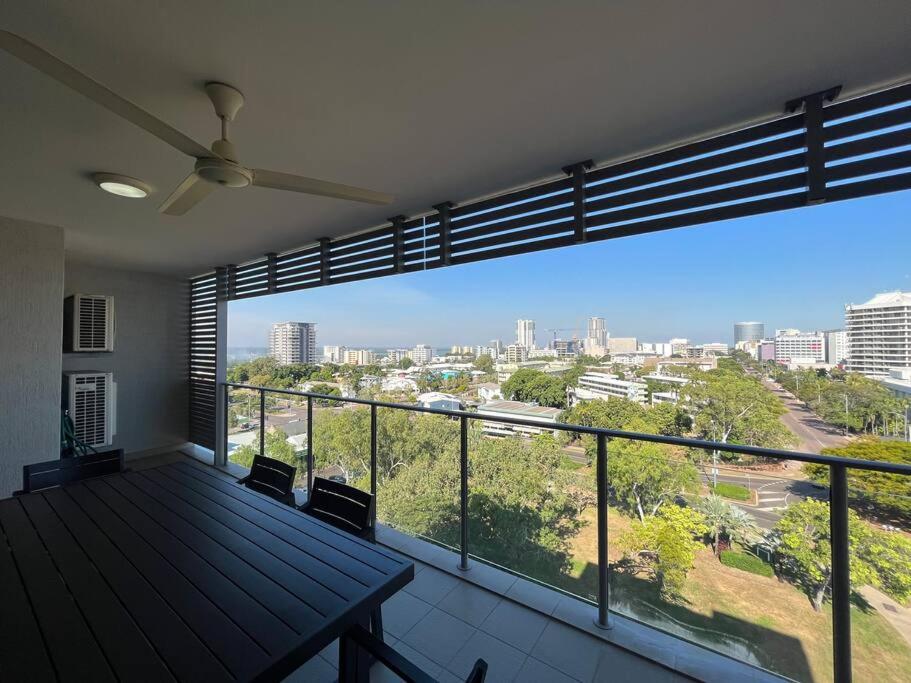 a balcony with a table and a view of a city at Kim on Smith, Darwin City in Darwin
