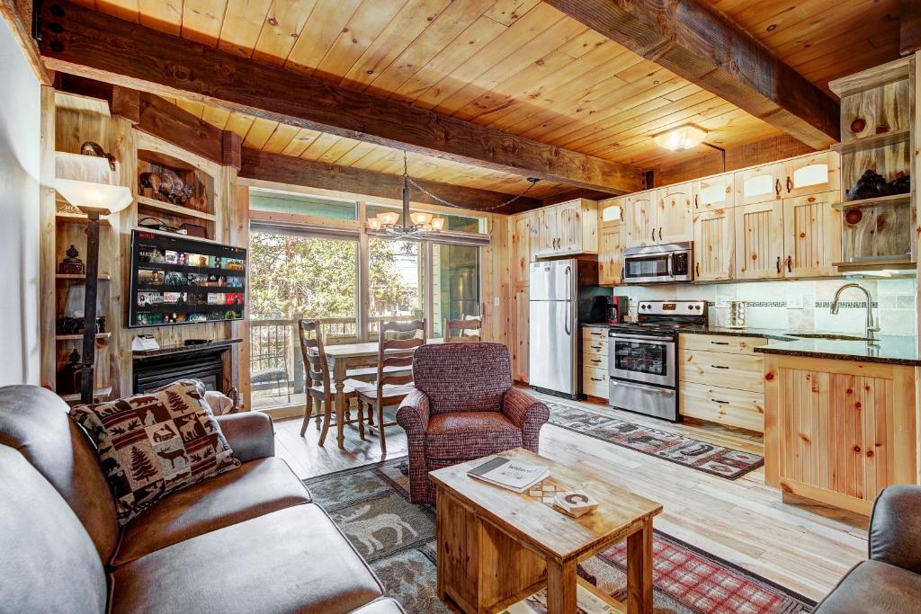a living room with a couch and a table at Two Bedroom Condo with Parking, Pool, Hot Tub - Steps to Main Street in Breckenridge