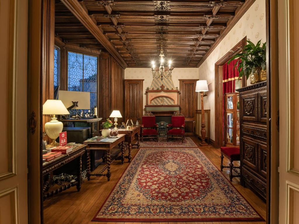 a hallway with a living room with a rug at Grand Hôtel Des Templiers in Reims