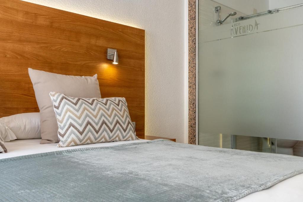 Posteľ alebo postele v izbe v ubytovaní Hotel Ecoavenida