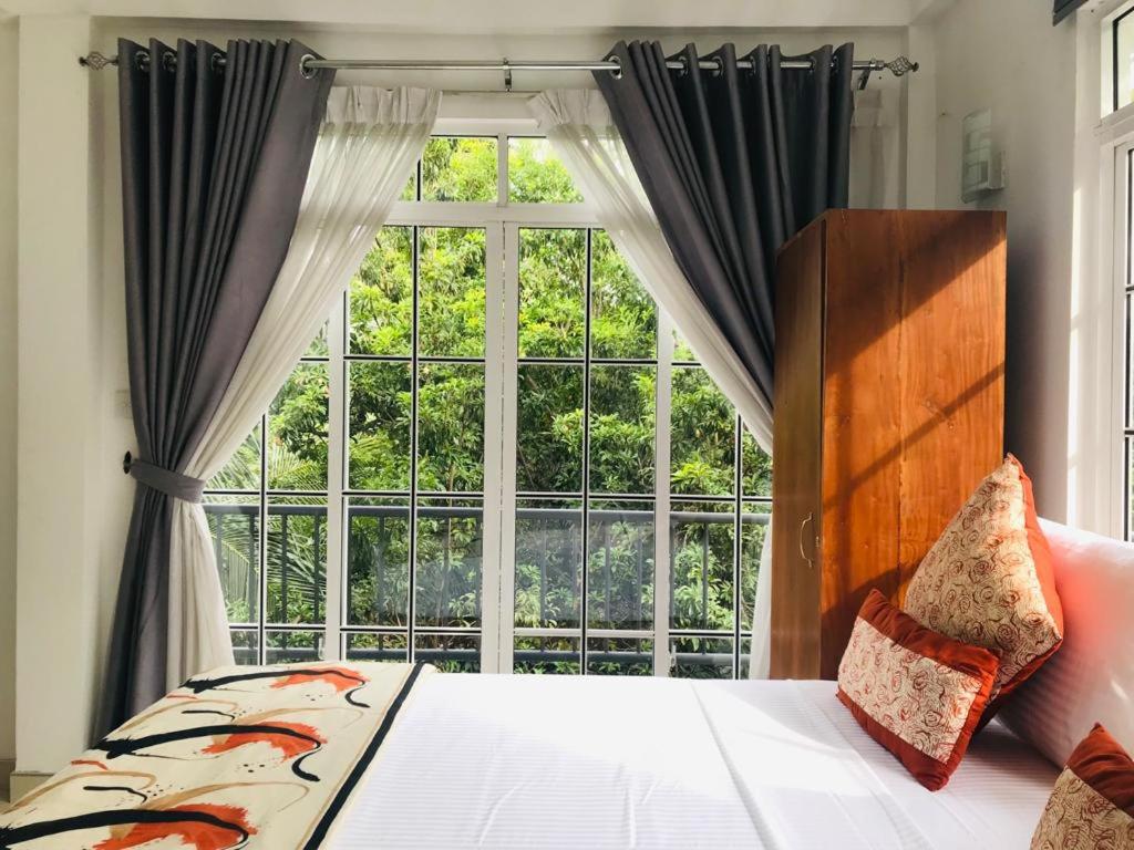 Ένα ή περισσότερα κρεβάτια σε δωμάτιο στο Kandy Traveller's Cottage
